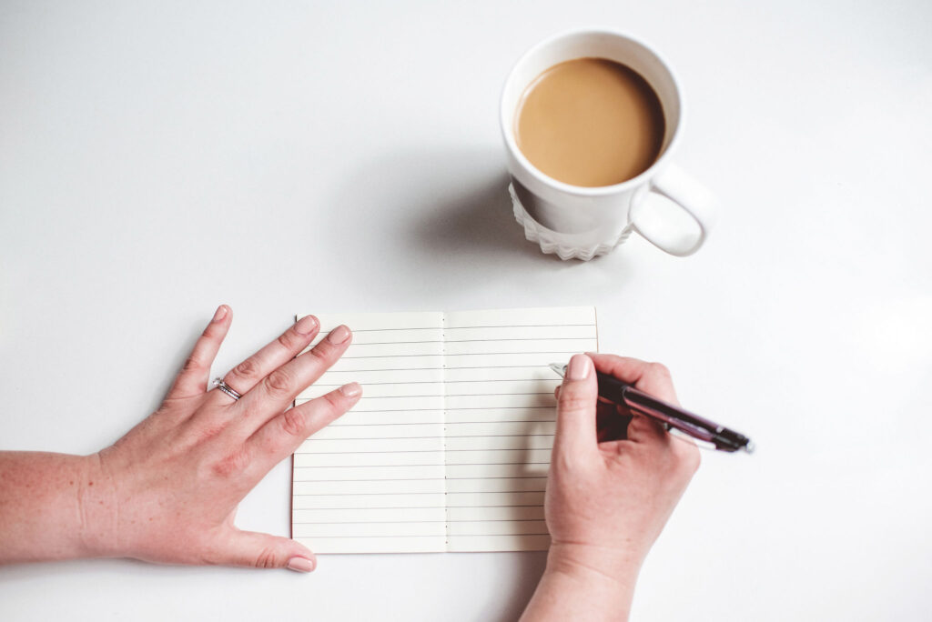 diet-culture a person about to write something on a black piece of paper- diet culture