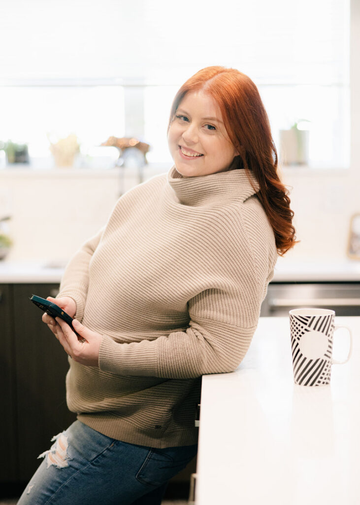 Woman staring at salad with frustration during clean eating cleanse and food restriction phase.