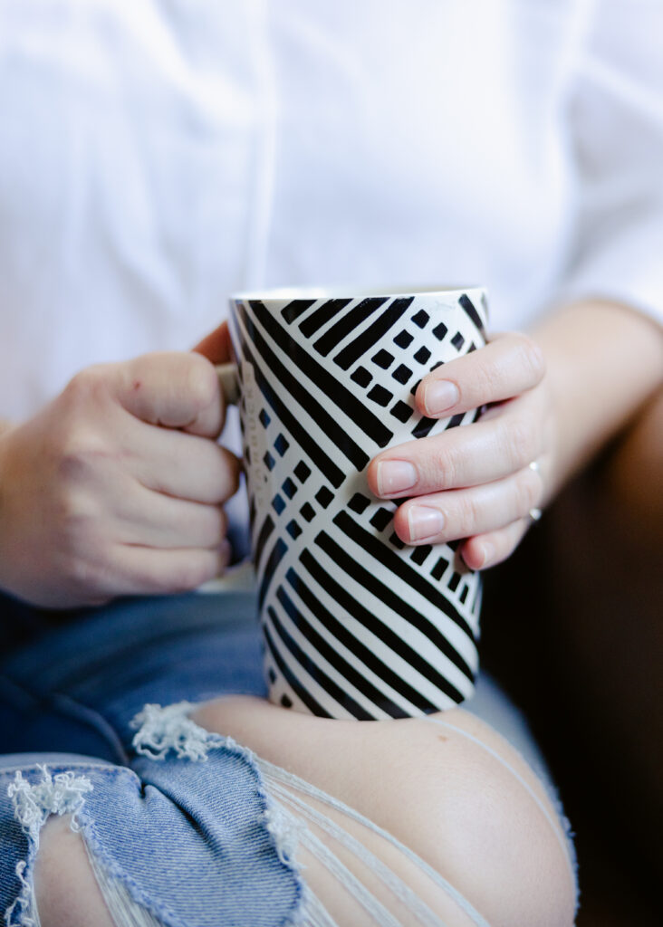Woman holding a mug while learning how to break sugar addiction and emotional eating patterns.