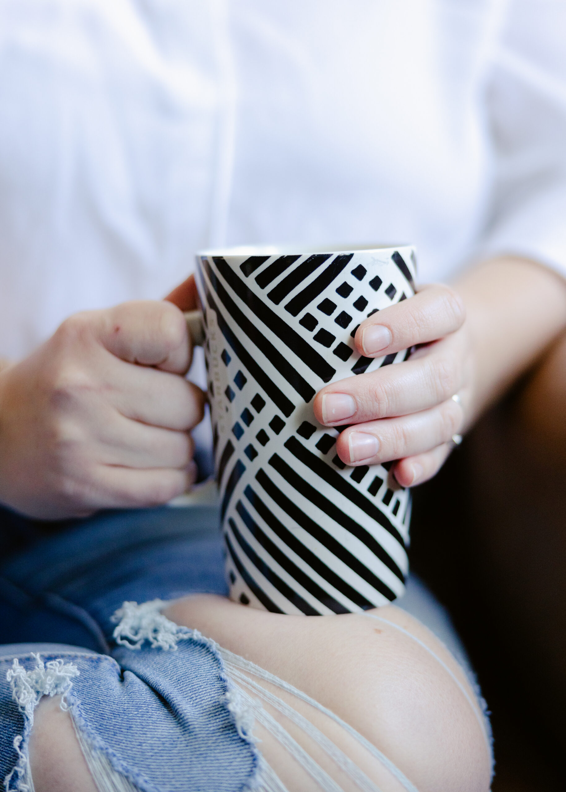 Woman holding a mug while learning how to break sugar addiction and emotional eating patterns.