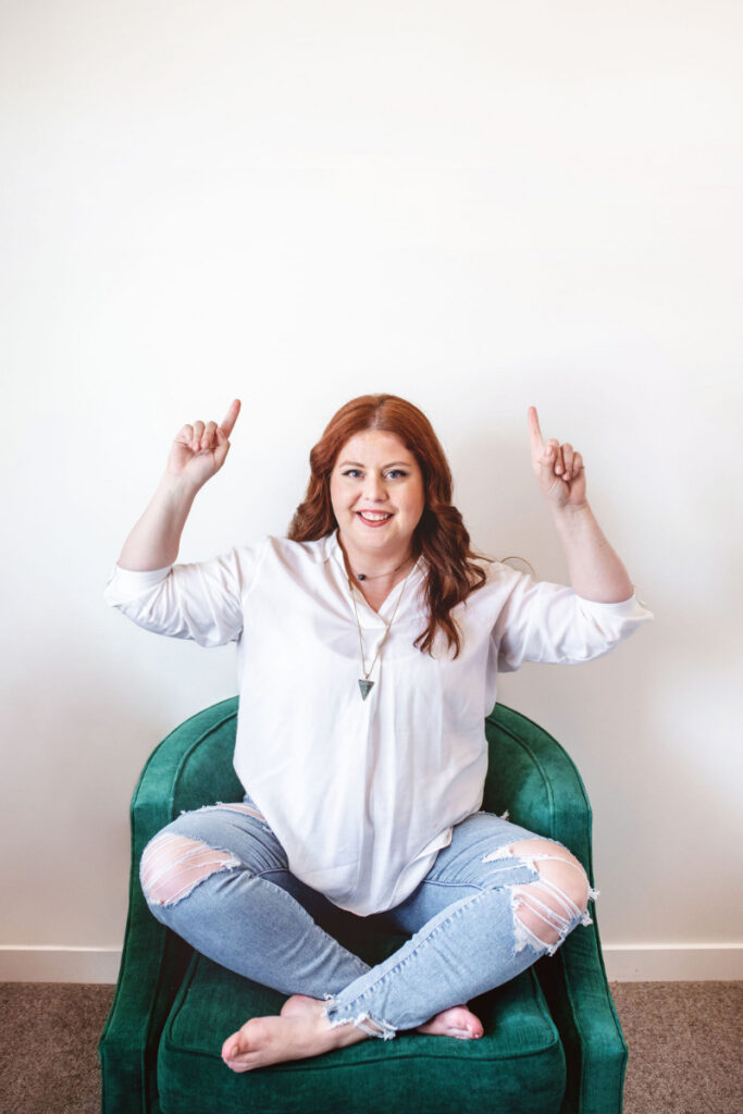 Dr. Meredith MacKenzie pointing upward while sharing helpful information about common binge eating triggers and recovery.